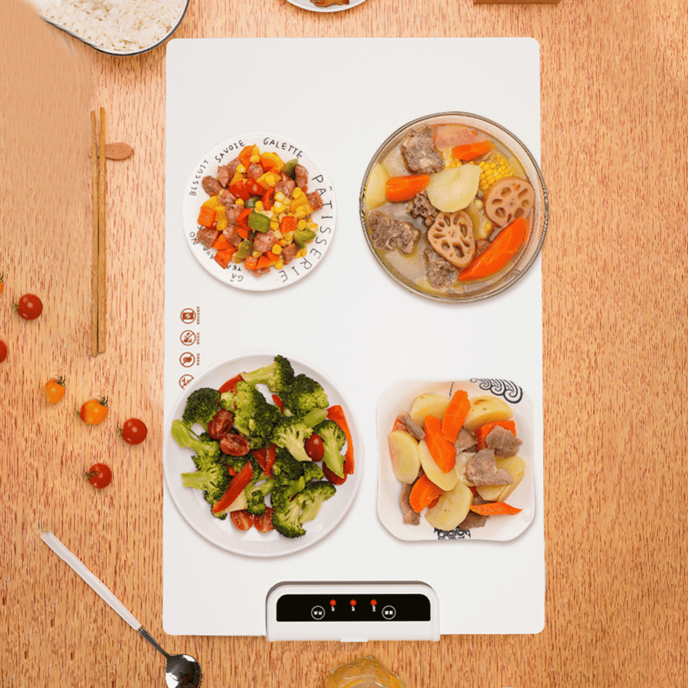 Heating mat with food items on a wooden surface
