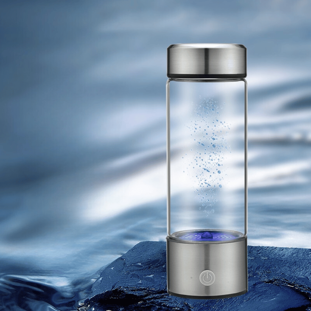 Glass water bottle with silver cap and base on a water background