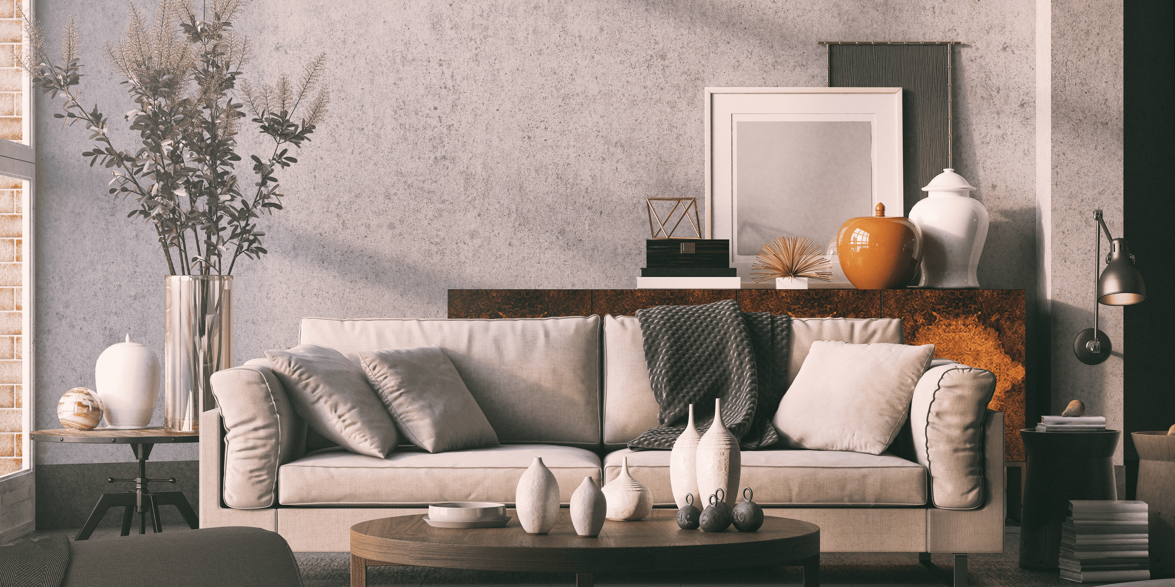 Modern living room with a gray sofa, decorative items, and a wooden sideboard.